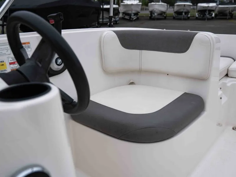 Slide: The Image of Interior of a 2016 Bayliner Element E16 boat with gray and white seating. - 13