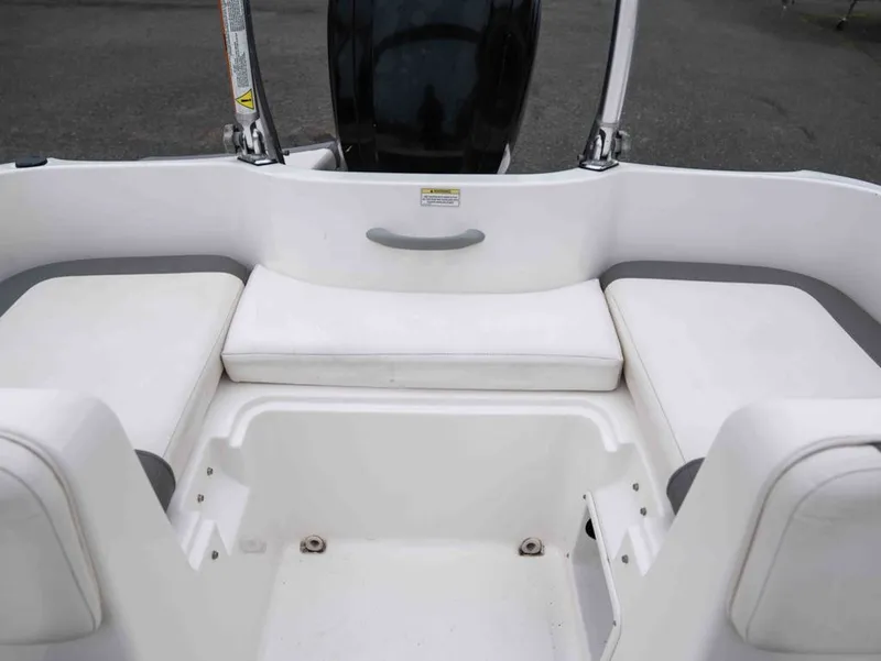 Slide: The Image of Interior of a 2016 Bayliner Element E16 boat with white seating. - 15