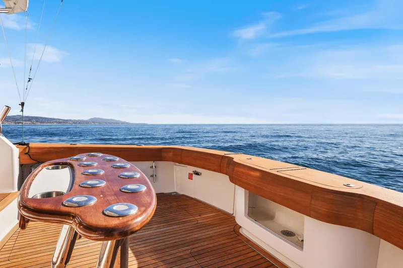 Slide: The Image of 2013 Viking 46 Convertible yacht deck with ocean view and clear blue sky. - 12