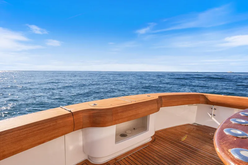 Slide: The Image of 2013 Viking 46 Convertible yacht deck with ocean view under clear blue sky. - 13