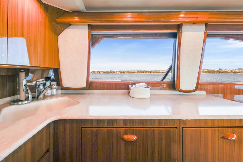 Slide: The Image of Luxurious interior of 2013 Viking 46 Convertible yacht with wooden cabinetry and ocean view. - 19