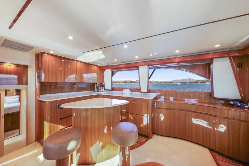 Slide: The Image of Luxurious interior of 2013 Viking 46 Convertible yacht with wooden cabinetry and scenic window view. - 25