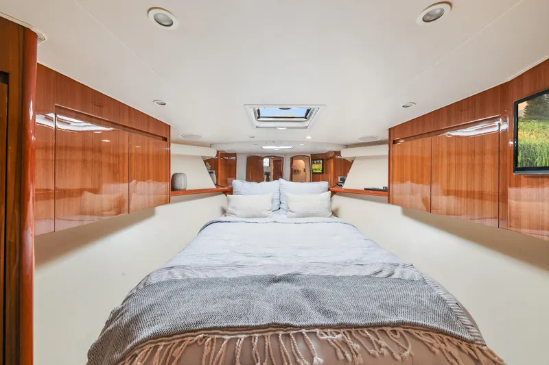 Slide: The Image of Luxurious interior of 2013 Viking 46 Convertible yacht with cozy bed and wooden cabinetry. - 27