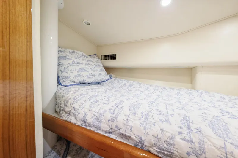 Slide: The Image of Cozy cabin bed in 2013 Viking 46 Convertible yacht with patterned bedding. - 35