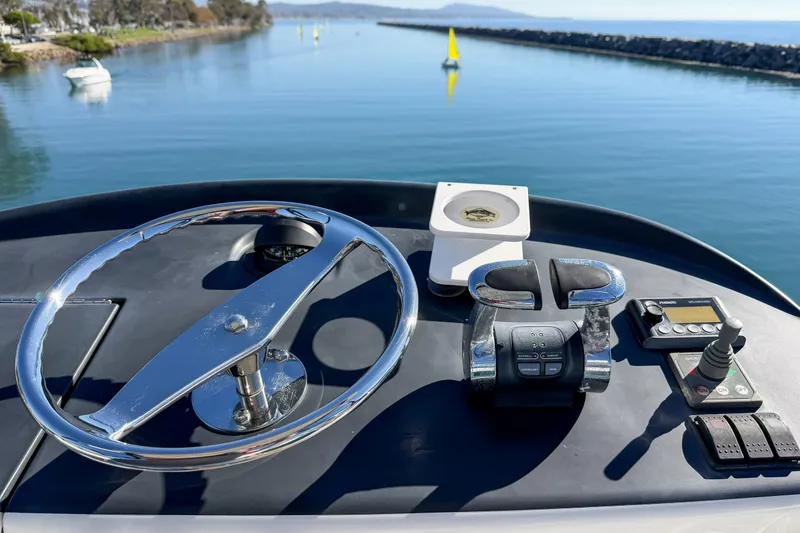 Slide: The Image of Control panel of a 2013 Viking 46 Convertible yacht with scenic waterway view. - 37