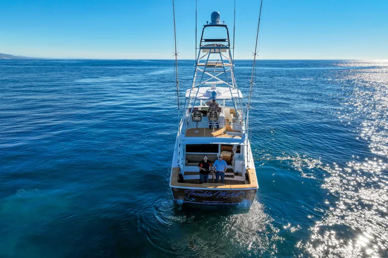 Slide: The Image of 2013 Viking 46 Convertible yacht cruising on open ocean under clear blue sky. - 4