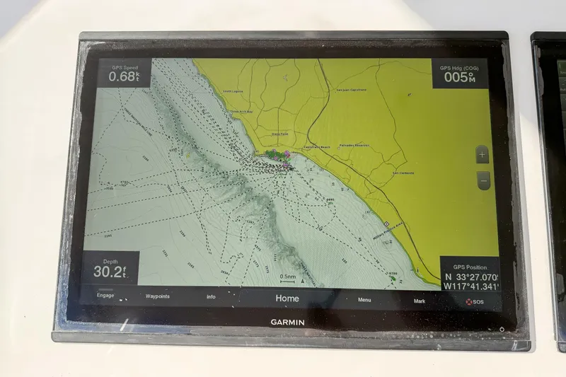 Slide: The Image of Garmin GPS display on 2013 Viking 46 Convertible, showing coastal navigation map and coordinates. - 46