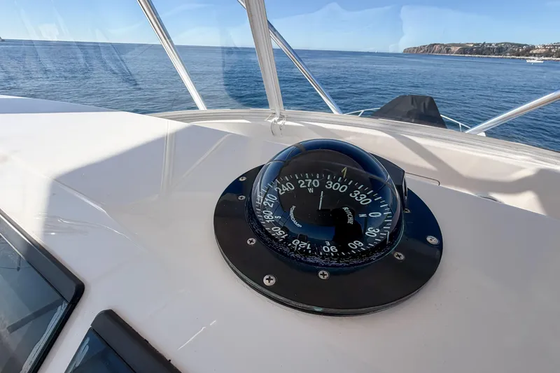 Slide: The Image of Compass on 2013 Viking 46 Convertible yacht, overlooking calm ocean waters. - 51