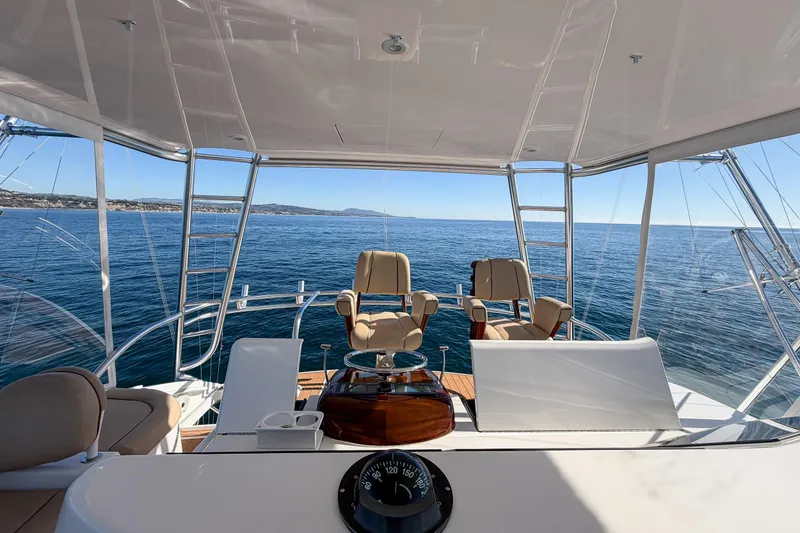 Slide: The Image of 2013 Viking 46 Convertible yacht interior with ocean view and seating area. - 54