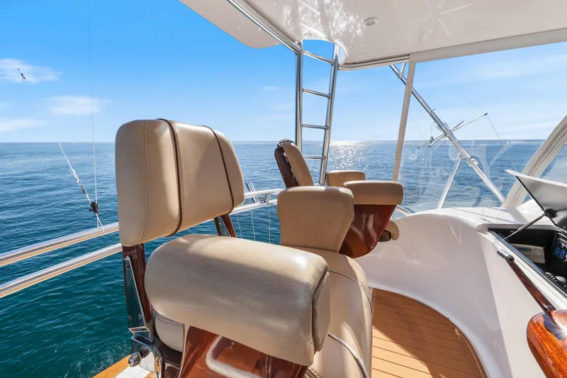 Slide: The Image of Luxury seating on 2013 Viking 46 Convertible yacht, overlooking ocean. - 58