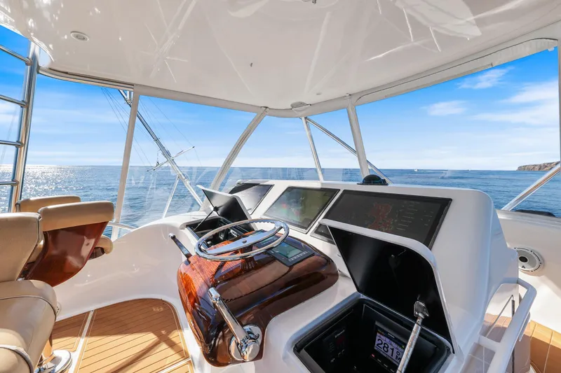 Slide: The Image of Helm of 2013 Viking 46 Convertible yacht with ocean view and navigation equipment. - 59