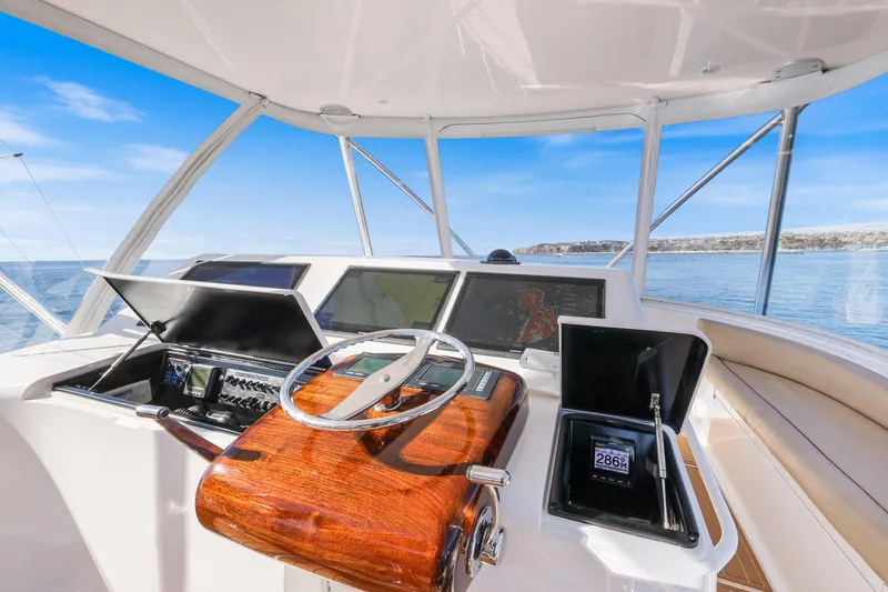 Slide: The Image of Helm of 2013 Viking 46 Convertible yacht with navigation equipment and ocean view. - 60