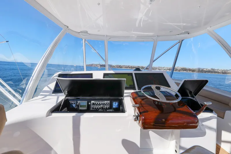 Slide: The Image of Helm of 2013 Viking 46 Convertible yacht with ocean view and navigation equipment. - 61