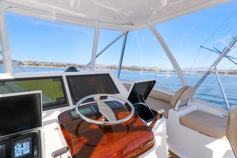 Slide: The Image of 2013 Viking 46 Convertible yacht helm with navigation screens and ocean view. - 62