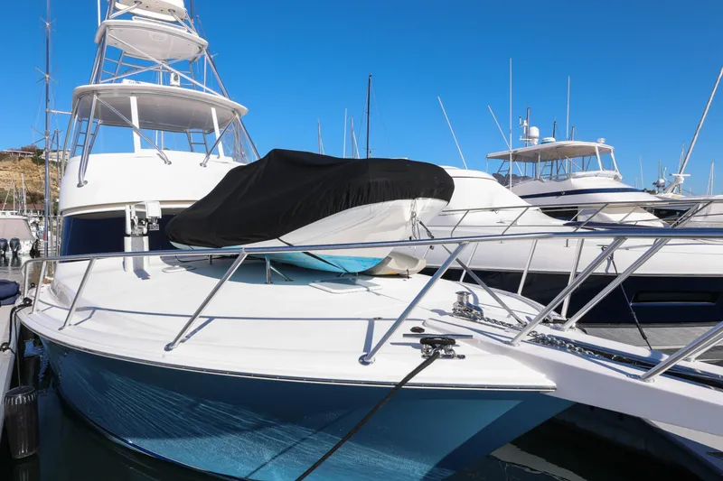 Slide: The Image of 2013 Viking 46 Convertible yacht docked at marina under clear blue sky. - 65
