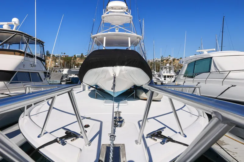 Slide: The Image of 2013 Viking 46 Convertible yacht docked in a marina, featuring sleek design and modern amenities. - 66