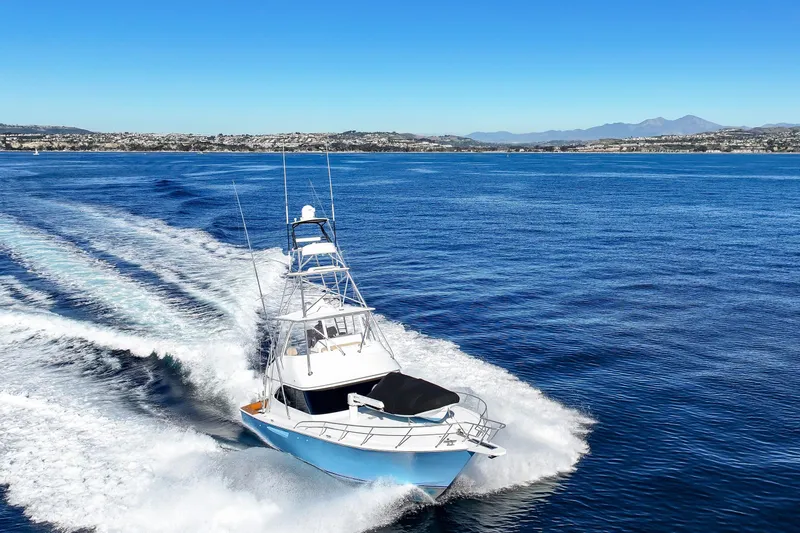 Slide: The Image of 2013 Viking 46 Convertible yacht cruising on open blue waters. - 70