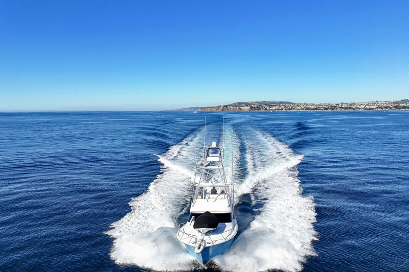 Slide: The Image of 2013 Viking 46 Convertible yacht cruising on open blue sea. - 71