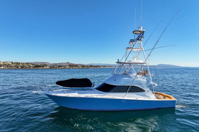 Slide: The Image of 2013 Viking 46 Convertible yacht on calm ocean waters under clear blue sky. - 78