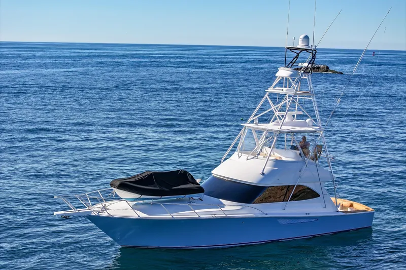 Slide: The Image of 2013 Viking 46 Convertible yacht on calm ocean waters. - 85