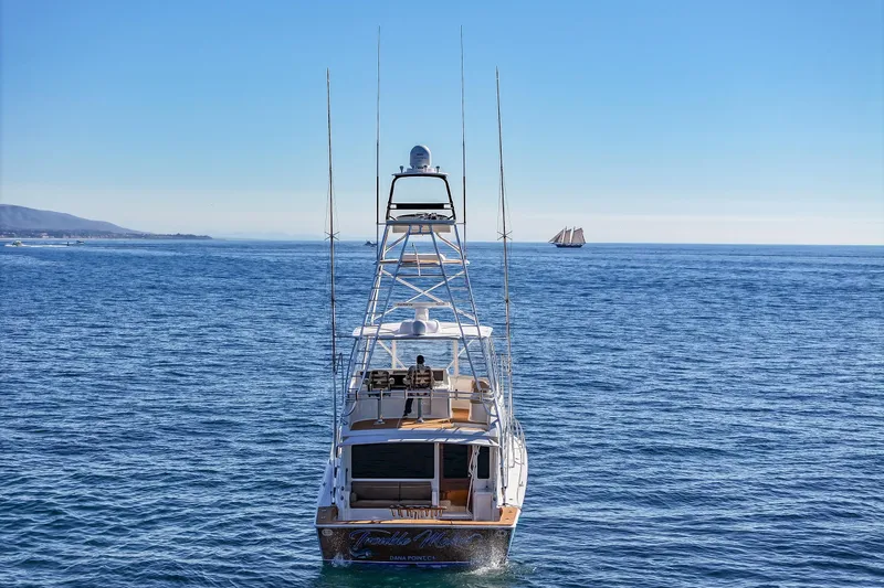 Slide: The Image of 2013 Viking 46 Convertible yacht on open sea with clear blue sky. - 86