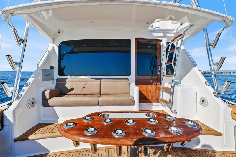 Slide: The Image of 2013 Viking 46 Convertible yacht interior with seating and wooden table. - 9