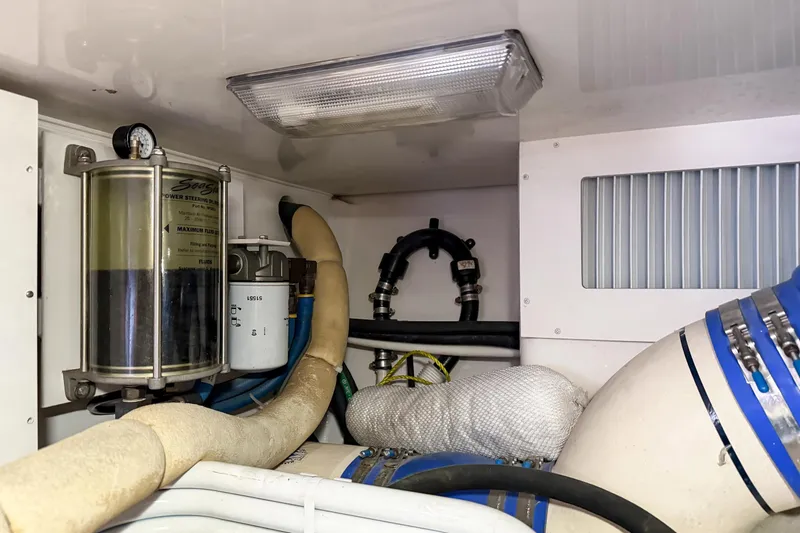 Slide: The Image of Engine room of 2013 Viking 46 Convertible yacht, showing power steering and filtration systems. - 90