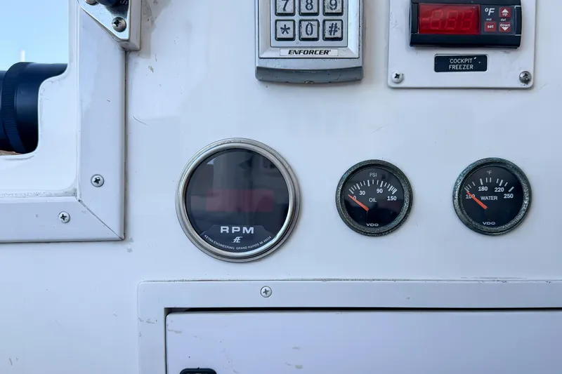 Slide: The Image of Control panel of a 2013 Viking 46 Convertible boat with gauges and keypad. - 95