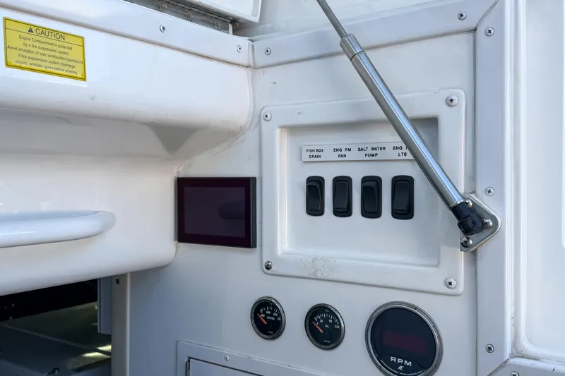 Slide: The Image of Control panel of a 2013 Viking 46 Convertible boat with switches and gauges. - 96