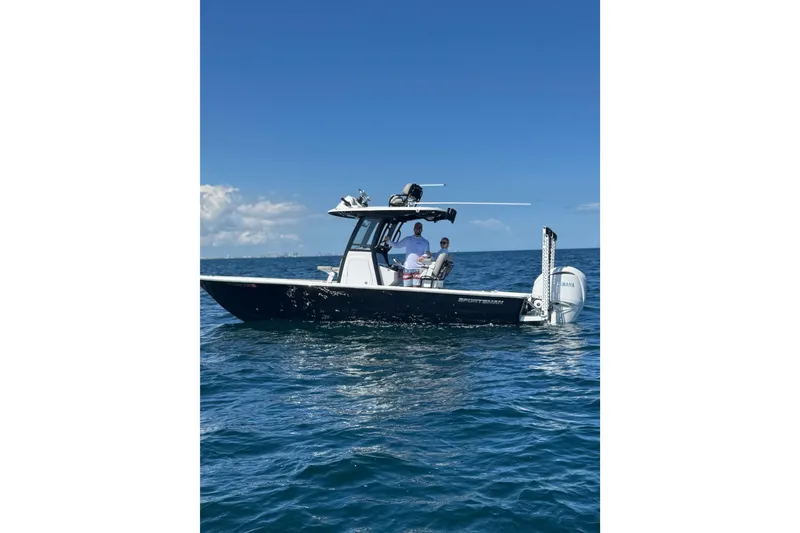 The Image of 2024 Sportsman Masters 247OE Bay Boat on open water under clear blue sky. - 0