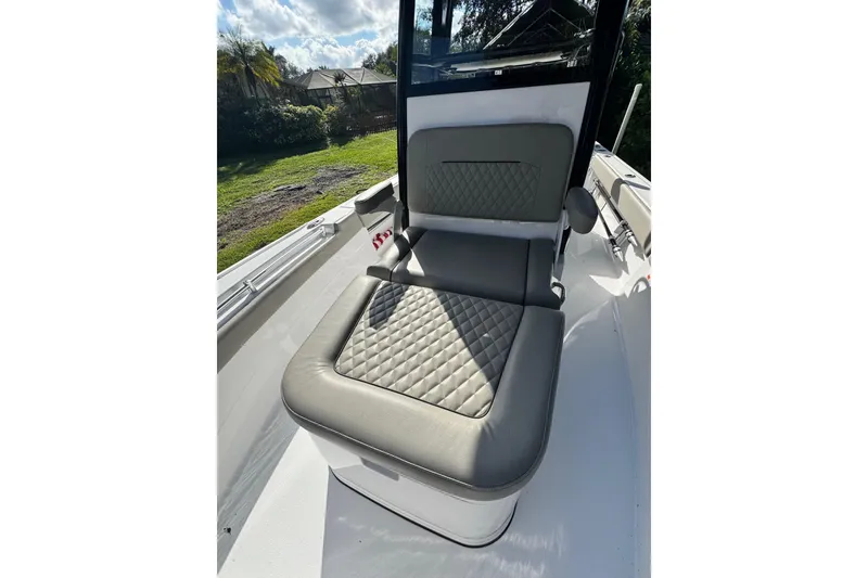 Slide: The Image of 2024 Sportsman Masters 247OE Bay Boat seat with quilted design, outdoor setting. - 13