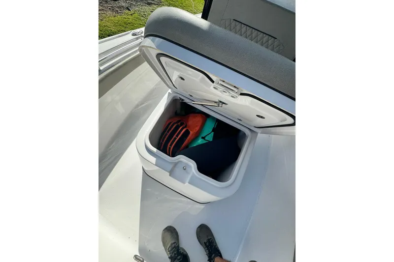 Slide: The Image of 2024 Sportsman Masters 247OE Bay Boat storage compartment with gear inside. - 15