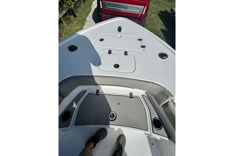 Slide: The Image of 2024 Sportsman Masters 247OE Bay Boat deck with storage compartments and cup holders. - 16