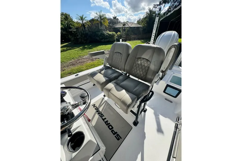 Slide: The Image of 2024 Sportsman Masters 247OE Bay Boat interior with dual seats and steering wheel. - 21