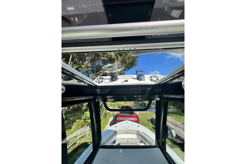 Slide: The Image of 2024 Sportsman Masters 247OE Bay Boat interior view with steering wheel and speakers. - 22