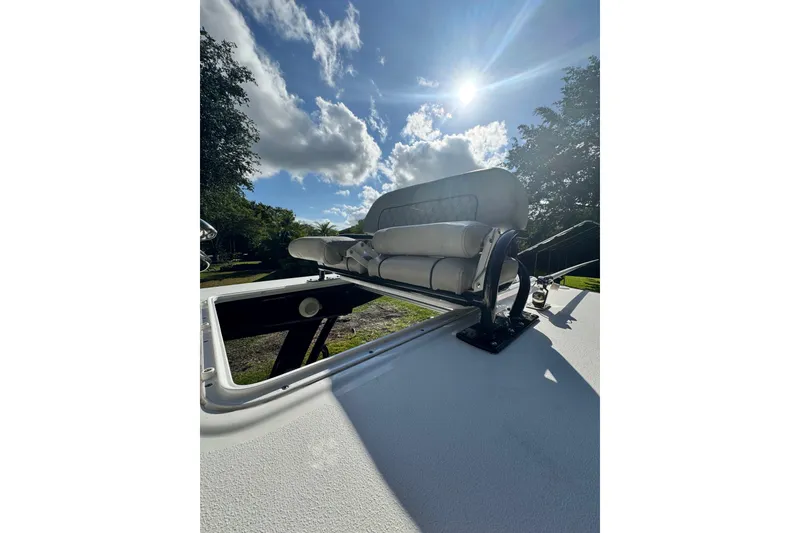 Slide: The Image of 2024 Sportsman Masters 247OE Bay Boat with cushioned seating under a sunny sky. - 23