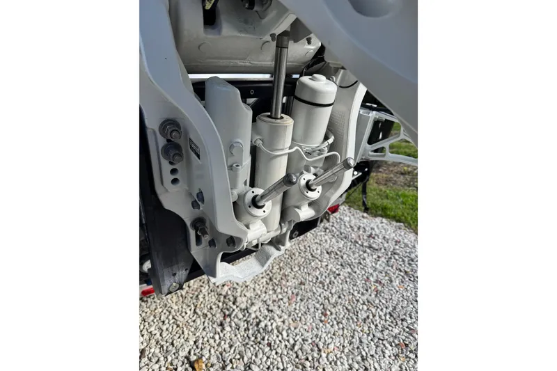 Slide: The Image of Close-up of 2024 Sportsman Masters 247OE Bay Boat engine components on gravel. - 28