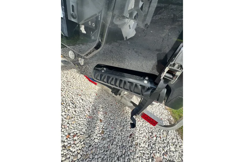 Slide: The Image of 2024 Sportsman Masters 247OE Bay Boat trailer detail on gravel surface. - 29