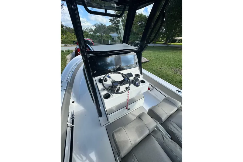 Slide: The Image of 2024 Sportsman Masters 247OE Bay Boat cockpit with steering wheel and seating. - 6
