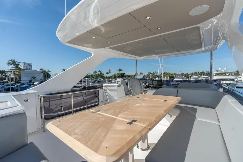 Slide: The Image of Luxurious 2026 Princess F58 yacht interior with marina view, featuring sleek seating and modern controls. - 11