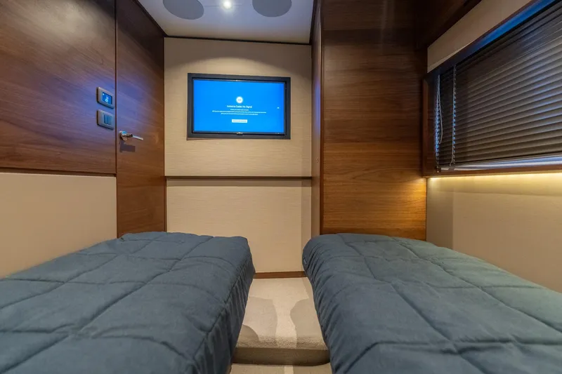 Slide: The Image of Luxurious bedroom interior of 2026 Princess F58 yacht with modern wood finishes and plush bedding. - 37