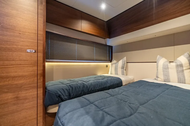 Slide: The Image of Luxurious cabin interior of 2026 Princess F58 yacht with twin beds and modern TV. - 38