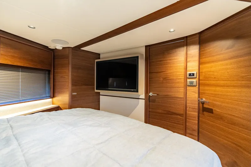 Slide: The Image of Luxurious cabin interior of 2026 Princess F58 yacht with wood paneling and cozy bedding. - 40