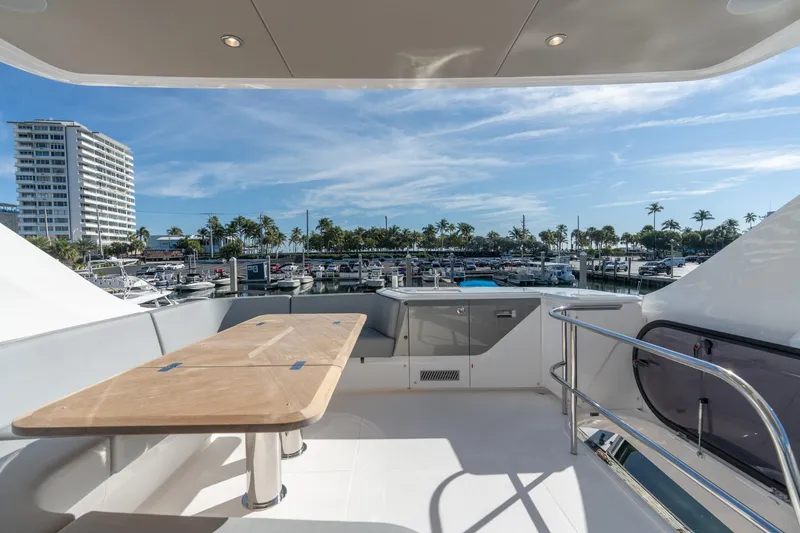 Slide: The Image of Luxury yacht Princess F58, 2026 model, docked in a sunny marina with palm trees. - 8