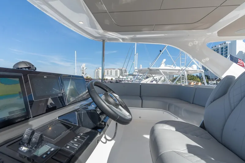 Slide: The Image of Luxurious 2026 Princess F58 yacht deck with marina view, featuring elegant seating and table. - 9