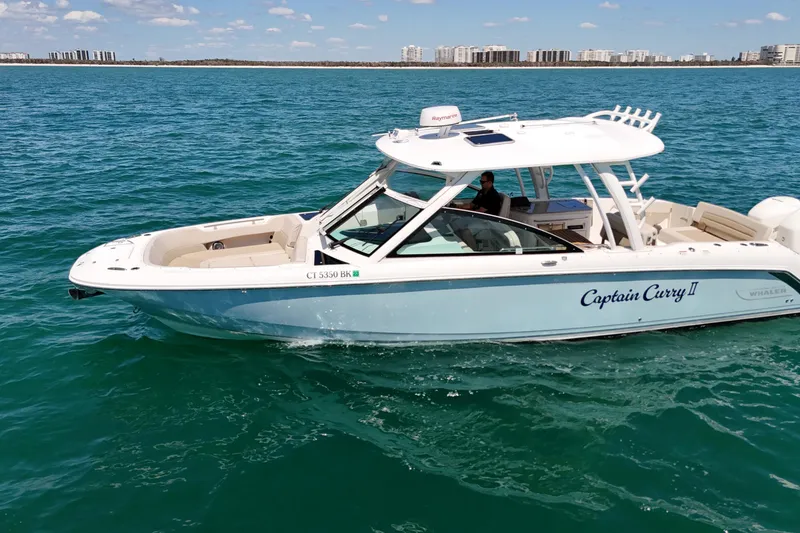 Slide: The Image of 2018 Boston Whaler 320 Vantage boat cruising on clear blue water. - 1