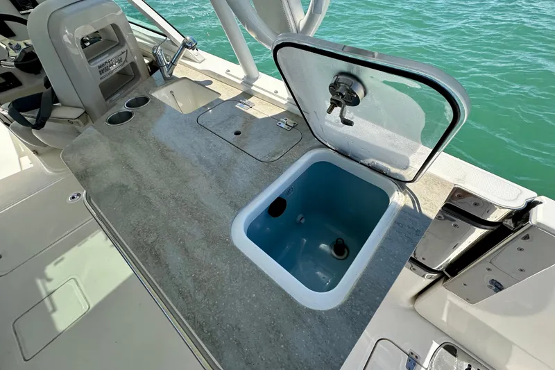 Slide: The Image of 2018 Boston Whaler 320 Vantage boat with open storage compartment and sink. - 19