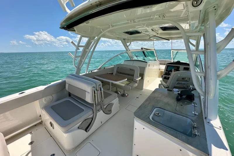 Slide: The Image of 2018 Boston Whaler 320 Vantage boat interior with seating and ocean view. - 2