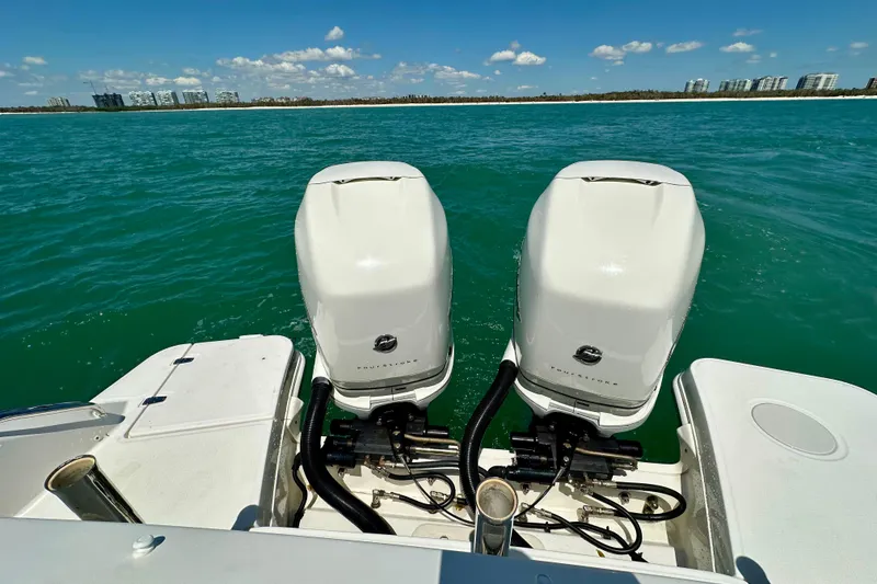 Slide: The Image of 2018 Boston Whaler 320 Vantage with dual outboard engines on open water. - 23