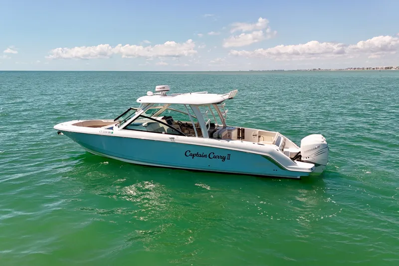 Slide: The Image of 2018 Boston Whaler 320 Vantage boat on open water under clear sky. - 30